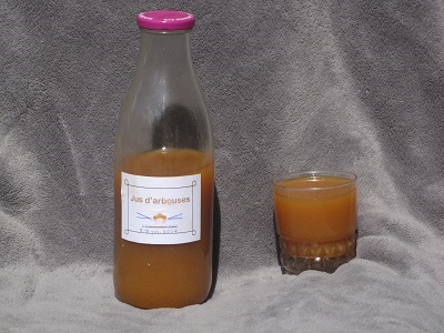 Bouteille et verre de jus d'arbouse.